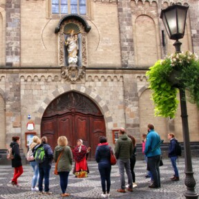 Führungsgruppe steht vor einer Kirche bei der Heilije, Hexe, Huckeweiwer Führung © Koblenz-Touristik GmbH, Johannes Bruchhof 