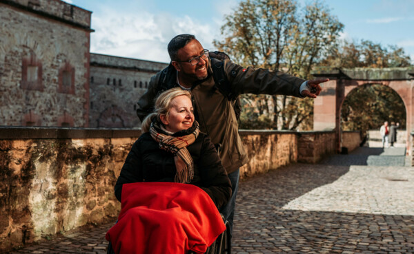 Man pushes his wife in a wheelchair through Ehrenbreitstein Fortress © Janko.Media
