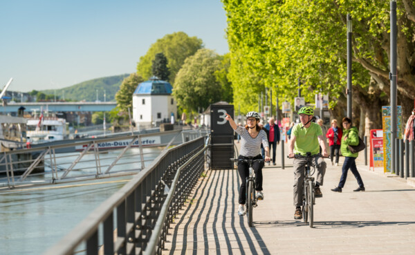 Paar fährt fahrrad entlang der Rheinanlagen ©
