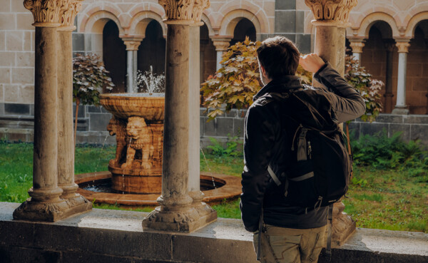 Man von Hinten blickt auf den Brunnen im Kloster Maria Laach ©Koblenz-Touristik GmbH, Philip Bruederle