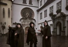 Bekleidet Stadtführer:innen stehen auf dem Jesuitenplatz in Koblenz bei Nacht