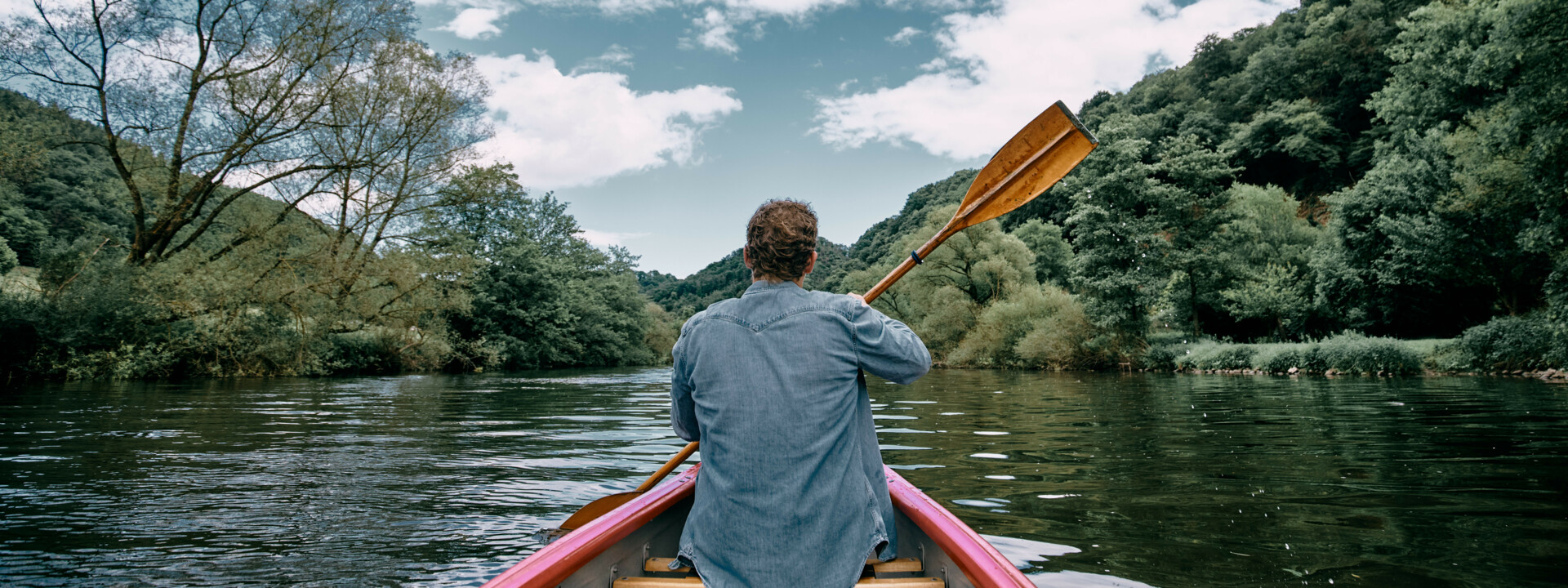 Mann von hinten, der in einem Kanu mit Paddel sitzt und über die Lahn fahrt  ©Koblenz-Touristik GmbH, Philip Bruederle