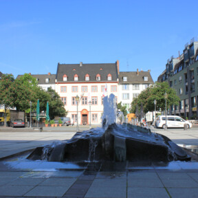 Brunnen auf dem Münzplatz mit Haus Metternich und Geschäfte im Hintergrund © Koblenz-Touristik GmbH