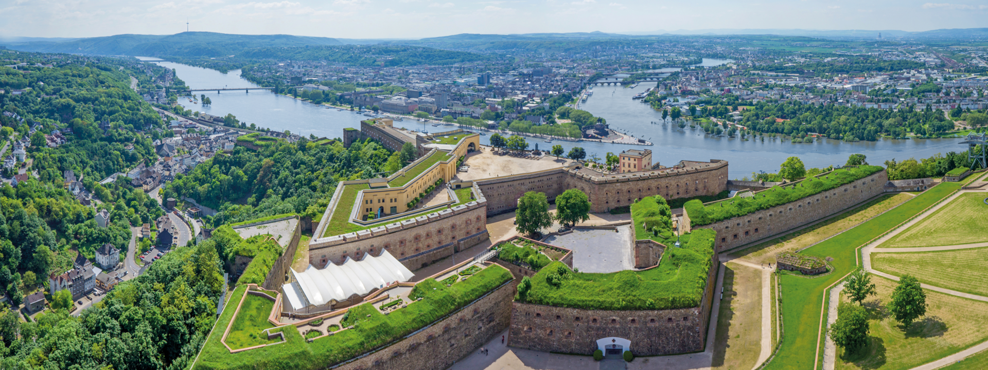 Die Festungsstadt Koblenz mit der Festung Ehrenbreitstein im Vordergrund, dahinter Rhein und Mosel sowie die Stadt Koblenz mit dem Deutschen Eck © Lufthelden Die Festungsstadt Koblenz mit der Festung Ehrenbreitstein im Vordergrund, dahinter Rhein und Mosel sowie die Stadt Koblenz mit dem Deutschen Eck © Lufthelden